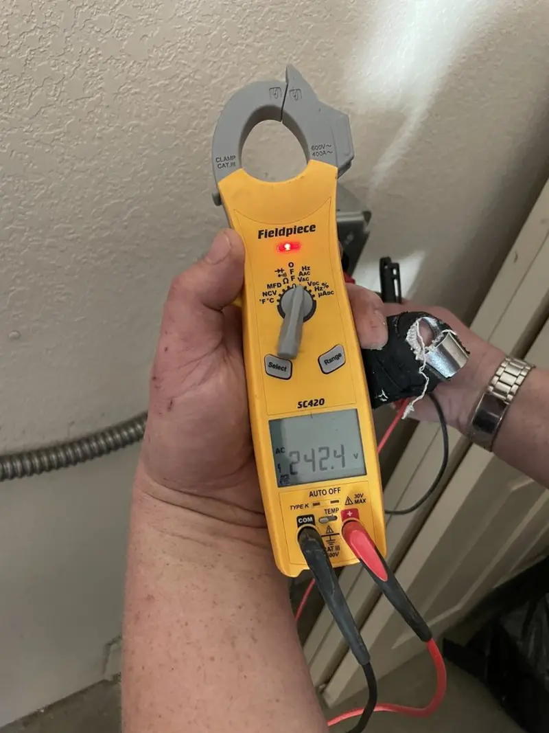 Voltage testing with clamp meter during Electrical Installation Services in Farmington Hills